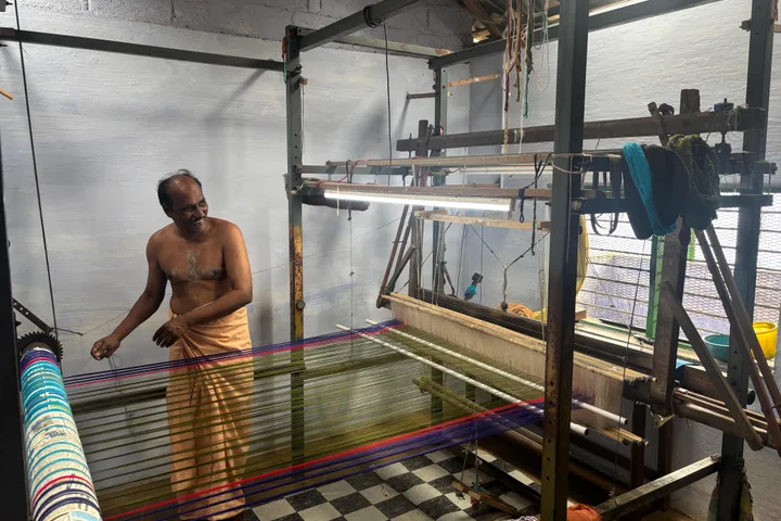 A weaver at a working handloom, from Oorva's silk-weaving collection