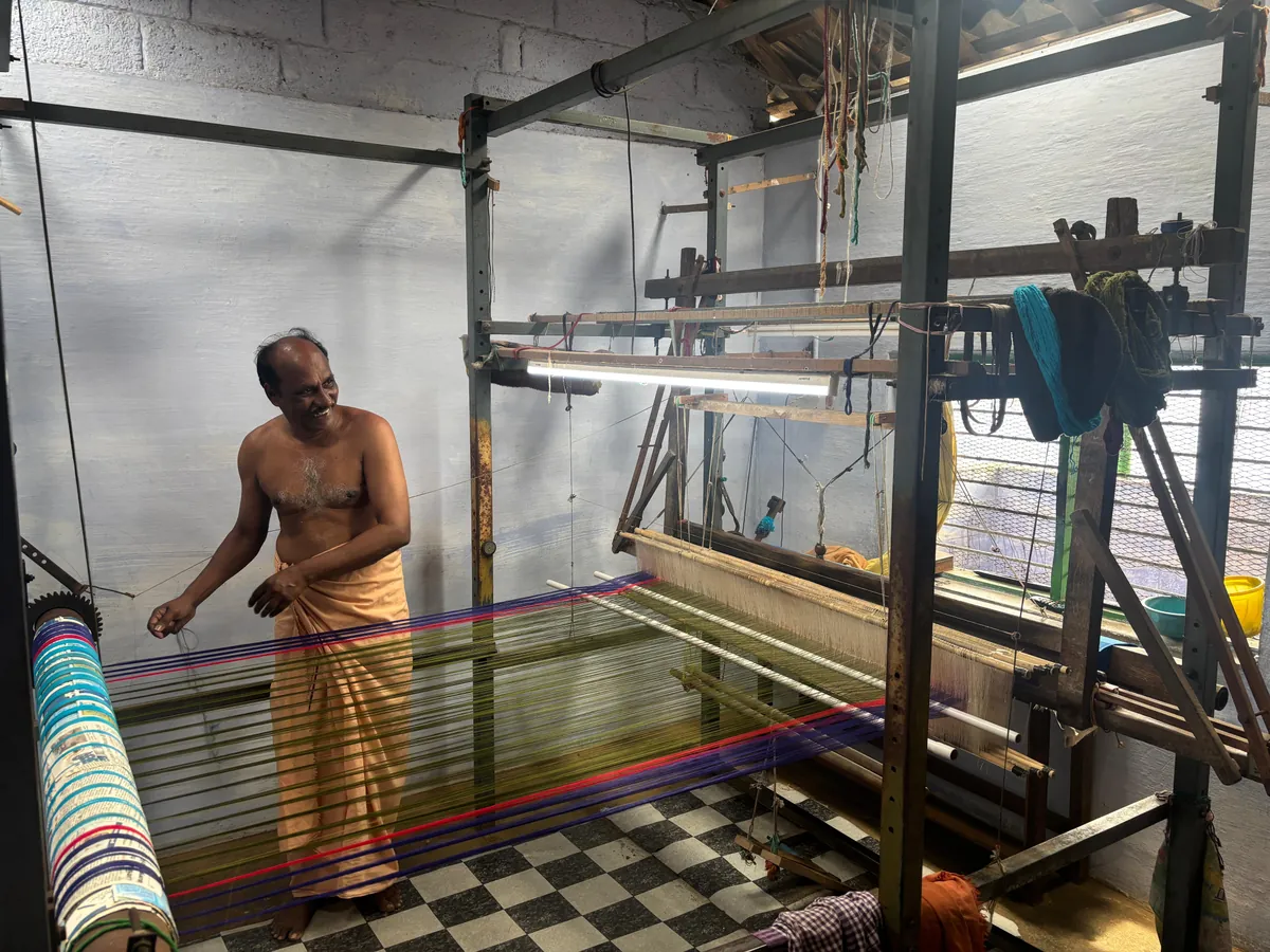 A weaver working at a traditional handloom